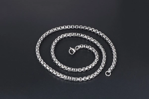Detailed macro shot of silver stainless steel box chain with secure lobster clasp