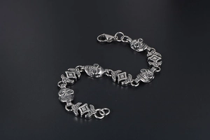 Macro shot of punk style skull link bracelet in vintage silver stainless steel finish