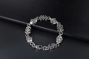 Macro shot of silver skull and cross chain links on a gothic men's steel bracelet