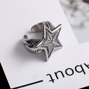 Detailed view of an adjustable star engraved titanium steel ring in silver finish