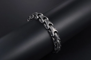 Close-up of titanium steel scale textured men's bracelet with intricate punk details