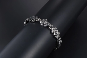 Macro shot of punk style stainless steel skull bracelet with detailed totem links