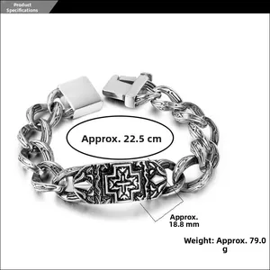 Macro detail of men's chunky stainless steel punk chain bracelet with cross engraved plaque
