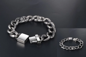 Detail of silver titanium steel bracelet featuring gothic engraved links and buckle