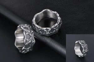 Detailed macro view of vintage star reliefs and irregular wavy edges on titanium steel ring