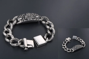 Close-up of vintage silver Cuban chain bracelet with engraved cross plate and secure clasp