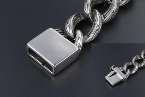 Macro view of vintage engraved steel chain bracelet with a square mechanical clasp