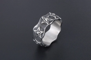 Macro view of wide vintage star ring featuring irregular wavy edges and antique finish