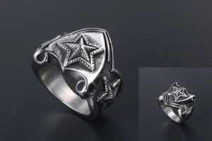 Macro view of men's stainless steel shield ring with star relief and vintage texture
