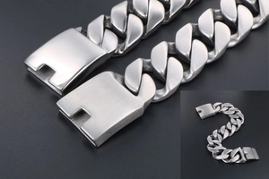 Détail macro de la texture en acier brossé d'un bracelet gourmette en argent mat