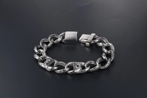 Macro shot of silver hip-hop chain with engraved patterns and a vintage oxidized finish
