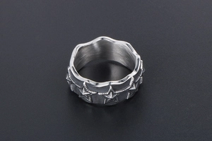 Macro shot of punk star ring with scalloped edges and vintage stainless steel relief