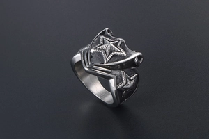 Macro detail of men's vintage stainless steel ring with 3D star and shield relief