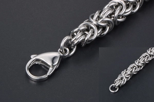 Close-up of silver stainless steel Byzantine chain bracelet with lobster claw clasp