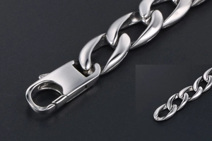 Macro shot of silver Cuban link chain bracelet with a secure lobster clasp closure
