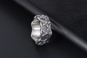 Detailed view of vintage wave-edged stainless steel ring with embossed stars