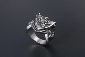 Macro shot of men's vintage steel ring with shield-shaped top and pentagram star relief
