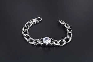 Detail of silver titanium steel Cuban chain bracelet with a large sparkling round zircon