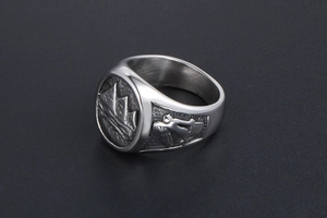 Macro view of vintage silver steel ring with detailed mountain and riding relief