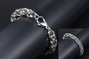 Detailed close-up of silver Byzantine chain bracelet with a classic lobster clasp lock