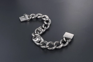 Macro detail of gothic style stainless steel bracelet with intricate engraved floral patterns