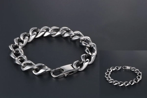 Macro detail of silver titanium steel Cuban chain link bracelet with large lobster clasp