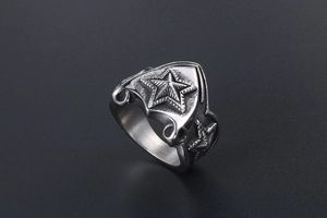 Detail of vintage stainless steel ring with 3D star carving and brushed texture