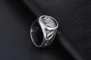 Detailed close-up of retro titanium steel ring with ancient Egyptian pyramid relief