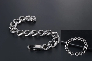 Detailed view of polished silver cuban chain bracelet for men with secure lobster clasp