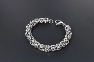 Close-up of Byzantine weave stainless steel bracelet with a secure lobster clasp