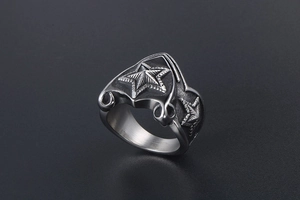 Macro detail of punk vintage stainless steel ring featuring embossed stars and textured edges