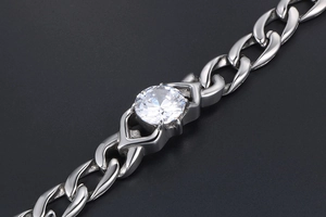 Macro shot of silver titanium steel Cuban chain bracelet with sparkling round zircon stone