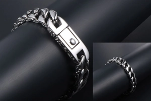 Detailed macro view of silver Cuban link bracelet with industrial push-button clasp