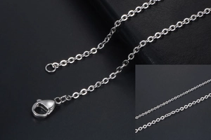 Macro shot of silver stainless steel cross chain link with a durable lobster clasp closure