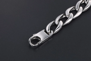 Macro shot of silver stainless steel Cuban link bracelet with lobster clasp detail
