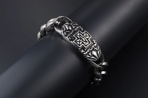 Macro detail of men's vintage titanium steel bracelet with cross plate and chain links