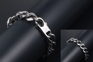 Detail view of silver stainless steel Cuban chain bracelet with a large lobster clasp buckle