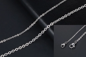 Macro detail of silver titanium steel O-chain link with durable lobster clasp closure