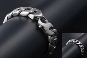 Detail of masculine titanium steel Cuban link bracelet with brushed finish and lobster clasp