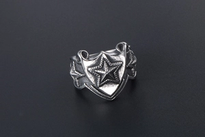 Macro detail of punk vintage stainless steel shield ring with 3D star engraving