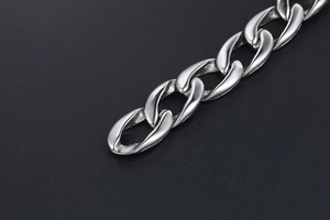 Macro shot of polished silver stainless steel cuban chain link bracelet detail