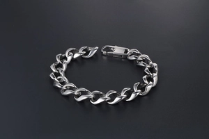 Close-up of silver Cuban link bracelet with unique faceted texture and spring buckle