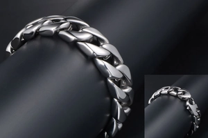 Macro view of polished stainless steel Cuban link bracelet with secure clasp mechanism