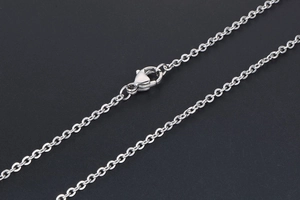 Macro shot of a minimalist silver titanium steel O-chain necklace with a secure lobster clasp