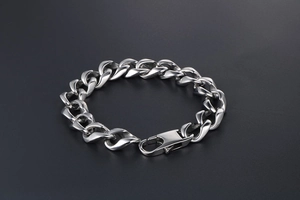 Detailed shot of polished titanium steel curb chain bracelet with secure lobster clasp