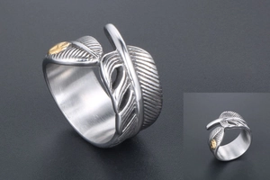 Detailed view of vintage silver feather ring with golden emblem and textured metal finish