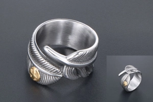 Detailed close-up of vintage feather ring with silver texture and golden eagle emblem