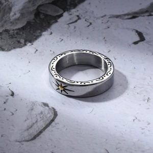 Macro view of vintage titanium steel ring with sunburst design and gold accents