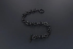 Close-up of black stainless steel rolo chain bracelet with a secure T-shaped toggle clasp