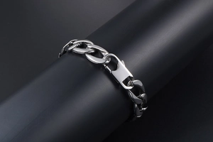 Detail of silver titanium steel Cuban link bracelet with large lobster clasp on display